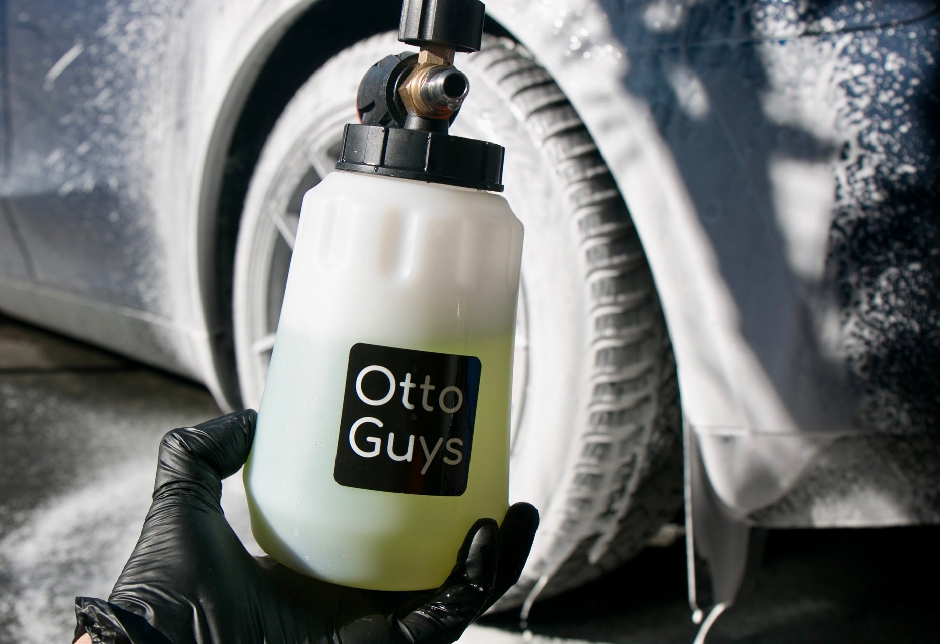 Holding up a foam cannon in front of a car
